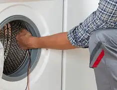 Dryer repair technician diagnosing and servicing a clothes dryer in Louisville, KY