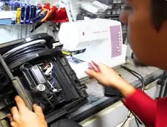 Vacuum repair technician servicing internal components on a workbench in Louisville, KY