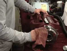 Vacuum repair technician cleaning and servicing a vacuum motor in Louisville, KY