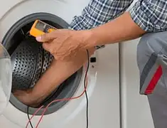 Washing machine repair technician testing a front-load washer with diagnostic tools in Louisville, KY